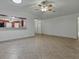 Open-concept living room featuring tile floors and a view to the breakfast area at 409 Westwood Dr, Leesburg, FL 34748