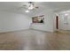 Spacious living room featuring ceramic tile flooring, ceiling fan, and ample natural light at 409 Westwood Dr, Leesburg, FL 34748