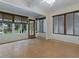 The sunroom with tile floor features many large windows and a ceiling fan at 409 Westwood Dr, Leesburg, FL 34748