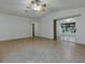 Expansive living room with tile flooring, ceiling fan and access to the lanai at 409 Westwood Dr, Leesburg, FL 34748