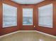 Empty room with hardwood floors, fresh paint and light-filled windows at 409 Westwood Dr, Leesburg, FL 34748