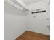 A walk-in closet features hardwood floors and metal shelving at 409 Westwood Dr, Leesburg, FL 34748