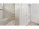 Shower with tile surround, built-in bench, grab bar, and glass door at 4157 Tiedemann Loop, The Villages, FL 32163