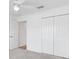 Bright bedroom featuring white walls, plush carpet, a closet, and a ceiling fan at 4157 Tiedemann Loop, The Villages, FL 32163