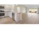 Open kitchen with stainless steel appliances, granite countertops, and an island that flows into the living area at 4157 Tiedemann Loop, The Villages, FL 32163