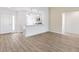 Inviting living area featuring light wood flooring, and seamless transition to the modern kitchen at 4157 Tiedemann Loop, The Villages, FL 32163