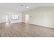Spacious living area with light wood floors, open layout, and kitchen view, perfect for modern living at 4157 Tiedemann Loop, The Villages, FL 32163