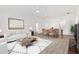 Bright living room boasts an open layout with a modern design and wood flooring throughout at 4157 Tiedemann Loop, The Villages, FL 32163