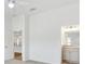 Main bedroom featuring bright ensuite and views into the kitchen at 4157 Tiedemann Loop, The Villages, FL 32163