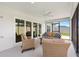 Inviting screened patio with comfortable seating and a view of the private backyard at 4157 Tiedemann Loop, The Villages, FL 32163