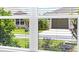 View from a window showcasing a manicured front yard and the home across the street at 4157 Tiedemann Loop, The Villages, FL 32163