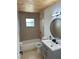Updated bathroom with a tub shower, a stylish vanity, and a wood plank ceiling at 460 Wisteria Ave, Umatilla, FL 32784