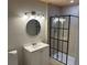Modern bathroom featuring a frameless glass shower enclosure and brushed nickel finishes at 460 Wisteria Ave, Umatilla, FL 32784