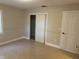 A bright bedroom features tile flooring, neutral paint, and a closet at 460 Wisteria Ave, Umatilla, FL 32784