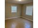 Bright bedroom with two windows, tile flooring, and neutral paint at 460 Wisteria Ave, Umatilla, FL 32784