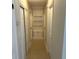 Hallway featuring built-in shelving, neutral paint and tile flooring at 460 Wisteria Ave, Umatilla, FL 32784