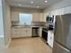 Modern kitchen featuring stainless steel appliances, white cabinets, and granite countertops at 460 Wisteria Ave, Umatilla, FL 32784