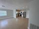 An open living room and kitchen area featuring tile flooring and stainless steel appliances at 460 Wisteria Ave, Umatilla, FL 32784