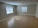 A bright and airy living room with tile floors and two large windows at 460 Wisteria Ave, Umatilla, FL 32784