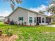 The home's backyard features a screened lanai, well-kept lawn, and mature landscaping at 4800 Tara View Rd, Leesburg, FL 34748