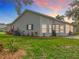 The backyard features an enclosed lanai, lush lawn, and mature plantings, offering privacy and charm at 4800 Tara View Rd, Leesburg, FL 34748