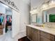 Bathroom featuring double sinks, modern fixtures, and a spacious closet at 4800 Tara View Rd, Leesburg, FL 34748
