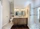 Elegant bathroom with double sinks, a glass shower, and modern fixtures at 4800 Tara View Rd, Leesburg, FL 34748