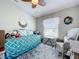 Charming bedroom featuring a bed, a ceiling fan, and a comfortable seating area at 4800 Tara View Rd, Leesburg, FL 34748