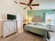 Bright bedroom featuring neutral tones, a ceiling fan, and ample natural light at 4800 Tara View Rd, Leesburg, FL 34748