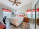 Bright bedroom with wood-look floors, ceiling fan, and mirrored closet doors; ample natural light at 4800 Tara View Rd, Leesburg, FL 34748
