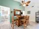 Bar with wooden counter and stools, open to dining area with views of other rooms at 4800 Tara View Rd, Leesburg, FL 34748