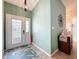 Light and airy entryway features a modern door, light green walls, and a stylish rug at 4800 Tara View Rd, Leesburg, FL 34748