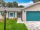 Attractive home with manicured lawn, updated walkway, teal shutters, and teal garage door at 4800 Tara View Rd, Leesburg, FL 34748