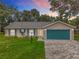 The home's front view features a meticulously manicured yard with tasteful landscaping, setting a welcoming tone at 4800 Tara View Rd, Leesburg, FL 34748