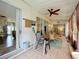 Enclosed patio featuring tiled flooring, ceiling fan, sliding glass doors, and comfortable seating at 4800 Tara View Rd, Leesburg, FL 34748