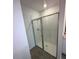 Modern glass enclosed shower with white tiles and tile flooring in a well-lit bathroom at 4957 Kaia Ave, Winter Haven, FL 33884