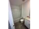 Bright bathroom with a tub-shower combo, vanity with solid surface top and cabinet at 4957 Kaia Ave, Winter Haven, FL 33884