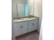 Bathroom features a double sink vanity with granite countertop and modern fixtures at 4957 Kaia Ave, Winter Haven, FL 33884