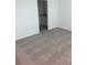 Bedroom area showing the neutral carpeting, light-colored walls, and bathroom entrance at 4957 Kaia Ave, Winter Haven, FL 33884