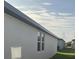 Side exterior view of the house showing a white wall and blue trim at 4957 Kaia Ave, Winter Haven, FL 33884