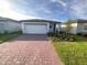 Charming one-story home featuring a brick-paved driveway and well-maintained landscaping at 4957 Kaia Ave, Winter Haven, FL 33884
