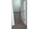 Hallway view showing the transition from tile flooring to carpet leading to a bedroom at 4957 Kaia Ave, Winter Haven, FL 33884