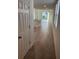 Bright hallway leading to an open-concept living space with modern tile flooring at 4957 Kaia Ave, Winter Haven, FL 33884
