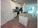 Bright kitchen with granite island, stainless appliances, and white cabinets at 4957 Kaia Ave, Winter Haven, FL 33884