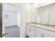 Bathroom with double granite vanity and an open doorway to the bedroom at 4973 Kaia Ave, Winter Haven, FL 33884