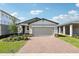 Charming one-story home featuring a brick driveway and two-car garage, beautifully landscaped at 4973 Kaia Ave, Winter Haven, FL 33884