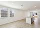 Open kitchen with a granite island, stainless appliances, and ample natural light at 4973 Kaia Ave, Winter Haven, FL 33884
