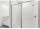 Modern glass-enclosed shower with white tiled walls and sleek fixtures at 4973 Kaia Ave, Winter Haven, FL 33884