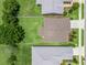 An aerial view shows a well-maintained lawn, house and neatly trimmed trees at 5019 Ne 125Th Loop, Oxford, FL 34484