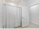 Bathroom featuring a tiled shower with glass door and an additional interior door at 5019 Ne 125Th Loop, Oxford, FL 34484